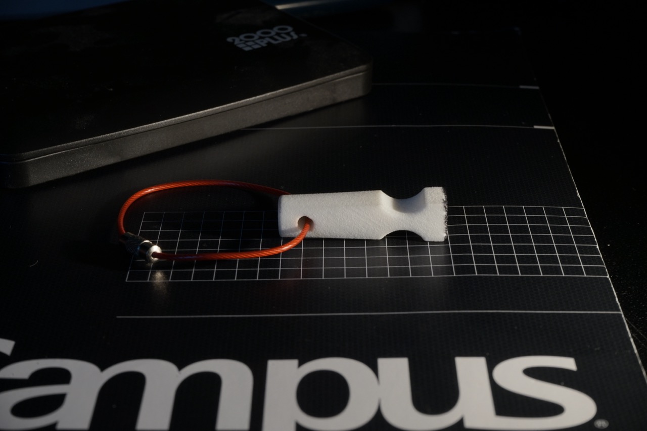 Profile view of the stamp showing the finger holds and knurled cable join